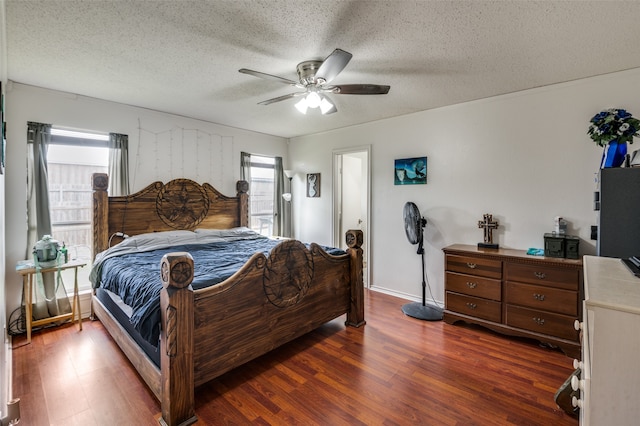 bedroom with ceiling fan, a textured ceiling, and hardwood / wood-style flooring