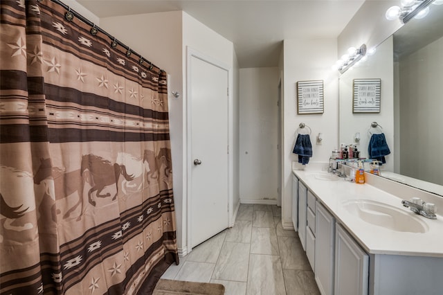 bathroom featuring tile flooring, oversized vanity, and double sink