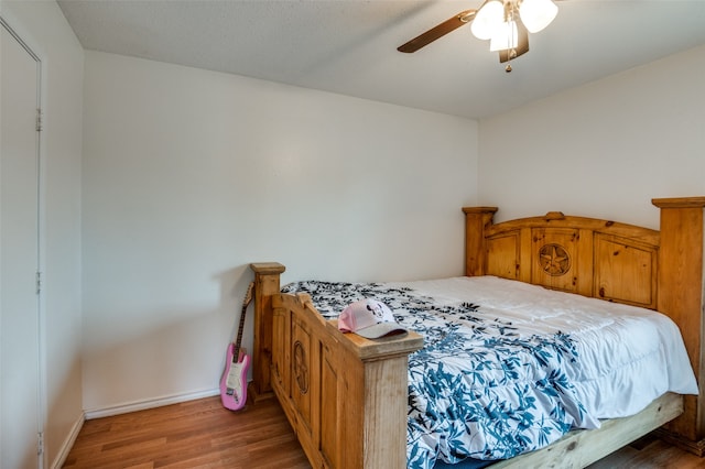 bedroom featuring ceiling fan and wood-type flooring