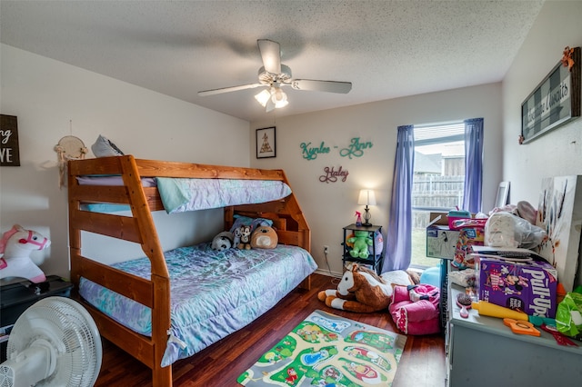 bedroom with a textured ceiling, ceiling fan, and hardwood / wood-style floors