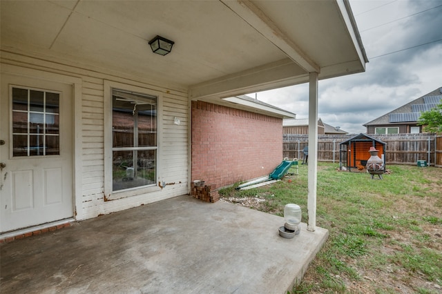 view of terrace with a storage shed