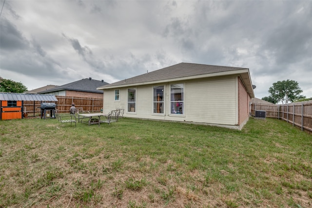 back of property featuring a lawn