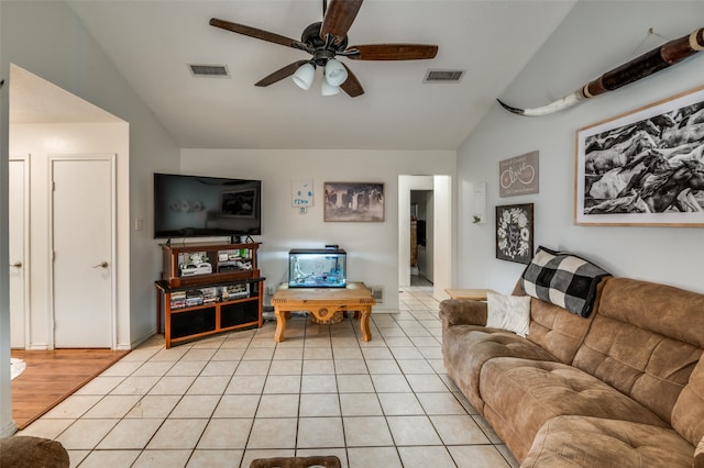 tiled living room with lofted ceiling and ceiling fan