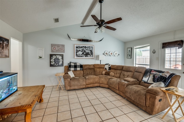 tiled living room with vaulted ceiling, ceiling fan, and a textured ceiling