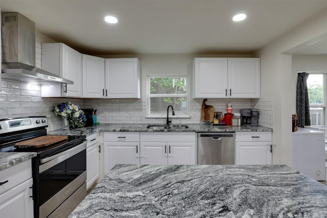 109 W Purdom Ave, Alvarado, TX 76009 - kitchen featuring appliances with stainless steel finishes, a sink, wall chimney exhaust hood, light stone counters, and recessed lighting