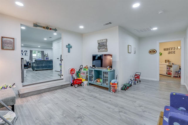 recreation room with light hardwood / wood-style flooring