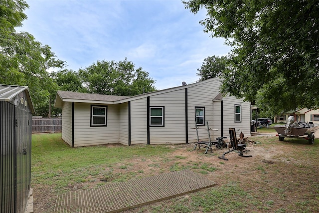 rear view of house with a lawn