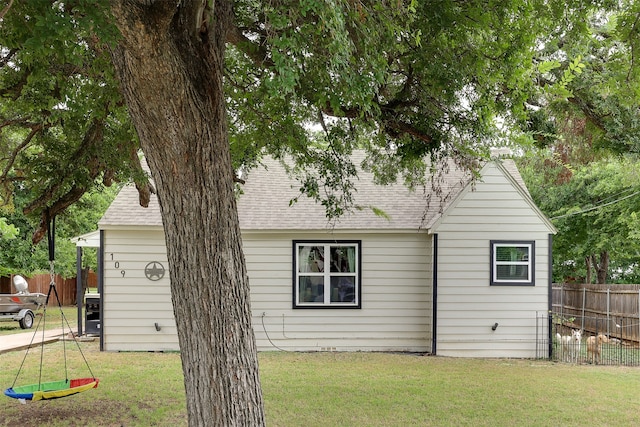 rear view of property with a lawn