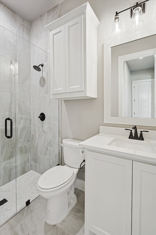 bathroom with vanity, toilet, and walk in shower