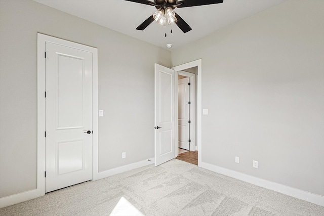 unfurnished bedroom with light colored carpet and ceiling fan