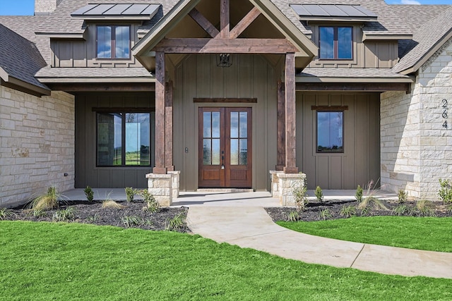 view of exterior entry with a lawn