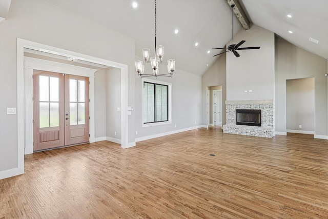 unfurnished living room with beam ceiling, high vaulted ceiling, and light hardwood / wood-style flooring