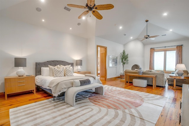 bedroom with ceiling fan, high vaulted ceiling, and light wood-type flooring