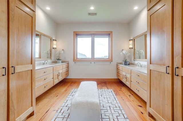 bathroom featuring vanity and hardwood / wood-style floors