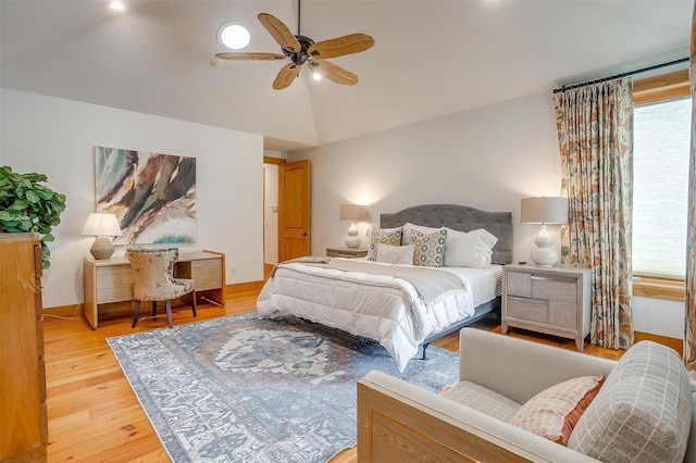 bedroom with high vaulted ceiling, ceiling fan, and light wood-type flooring