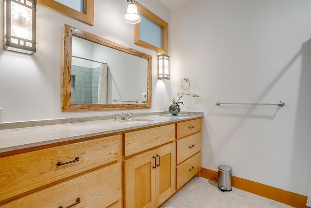 bathroom with tile flooring and large vanity