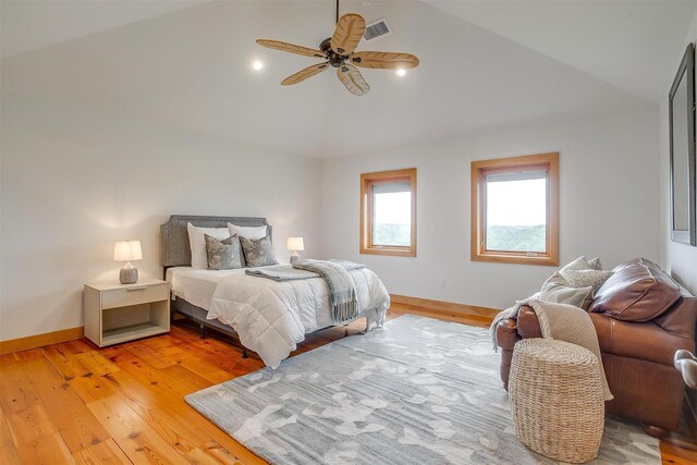 bedroom with ceiling fan, light hardwood / wood-style flooring, and lofted ceiling