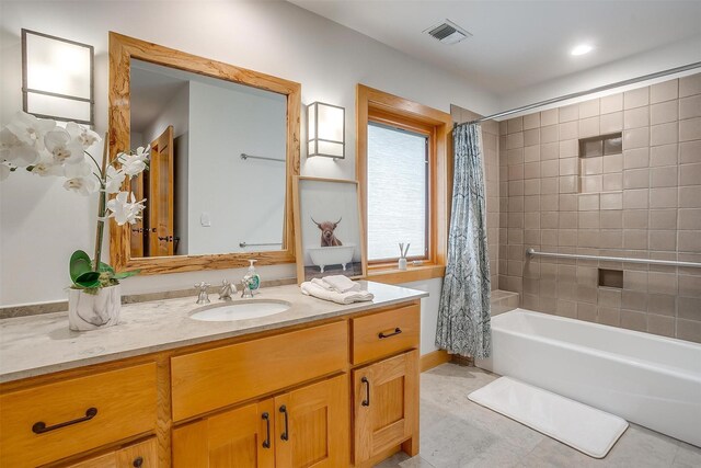 bathroom with tile floors, shower / tub combo with curtain, and vanity