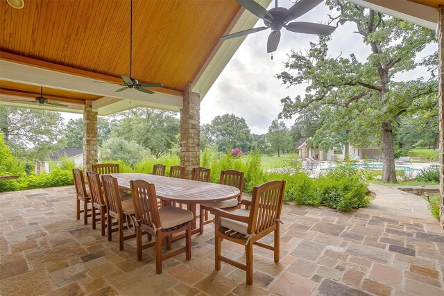 view of terrace featuring a swimming pool and ceiling fan