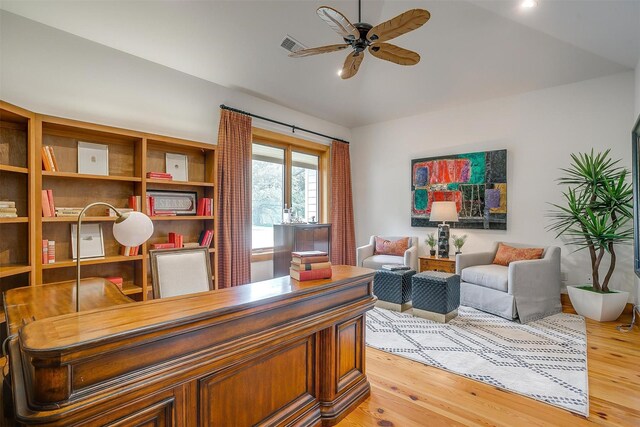 home office featuring ceiling fan and light hardwood / wood-style floors