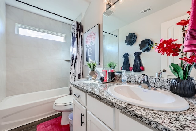 full bathroom featuring toilet, shower / bath combo with shower curtain, and large vanity