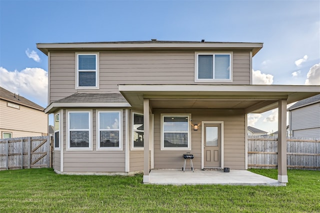 back of house featuring a yard and a patio