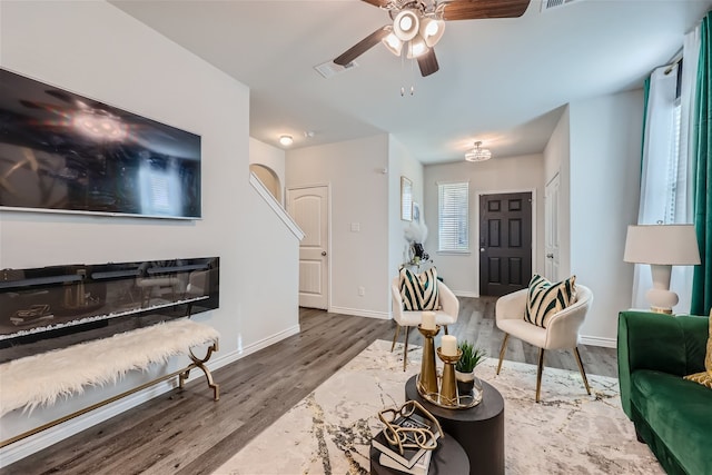 living room with wood-type flooring and ceiling fan