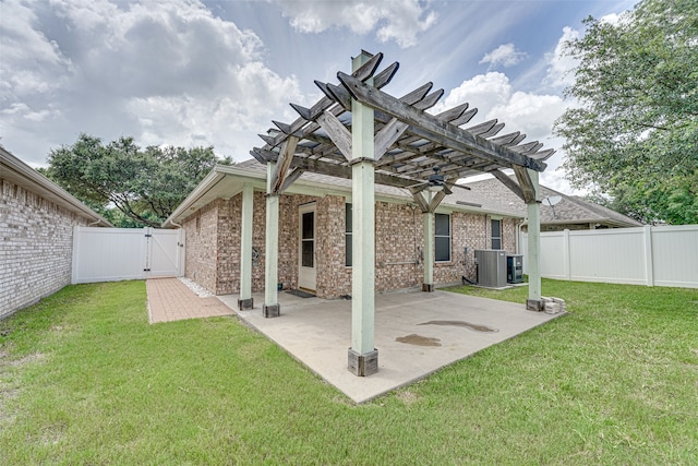 back of property with a patio area, a pergola, central air condition unit, and a yard