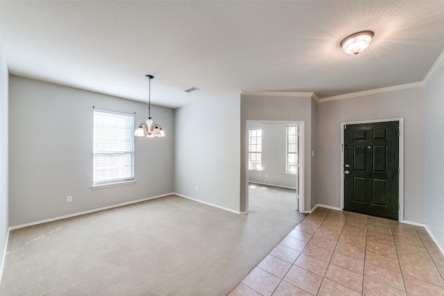 foyer entrance with visible vents, an inviting chandelier, ornamental molding, light colored carpet, and light tile patterned flooring