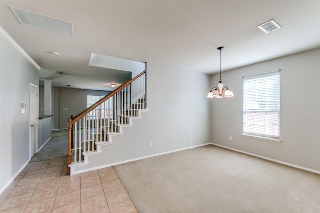 stairway featuring tile patterned floors, a notable chandelier, visible vents, and baseboards
