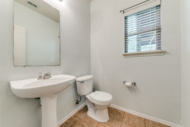 bathroom featuring tile patterned flooring and toilet