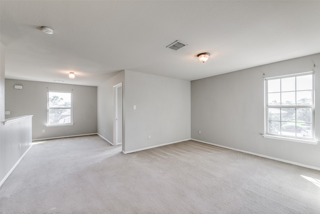 empty room with light colored carpet