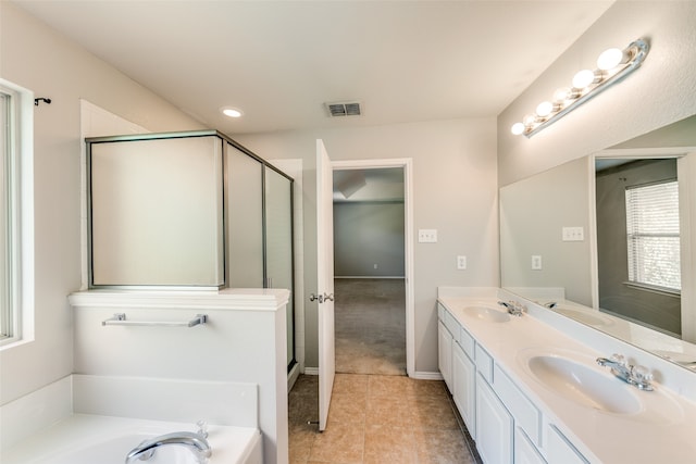 bathroom with tile patterned floors, independent shower and bath, and vanity