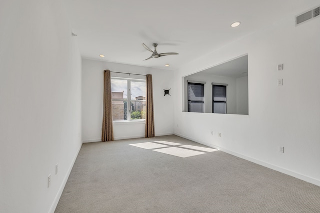 carpeted spare room featuring baseboards, a ceiling fan, visible vents, and recessed lighting