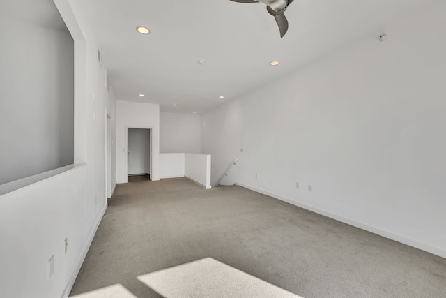 carpeted spare room with ceiling fan, baseboards, and recessed lighting
