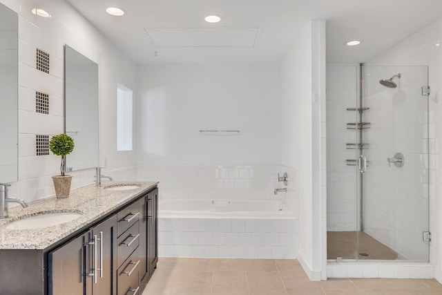 bathroom with tile patterned flooring, a garden tub, a sink, and a shower stall