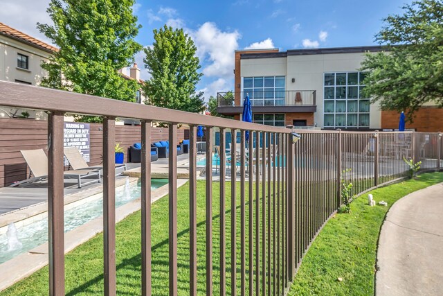 view of swimming pool with a yard