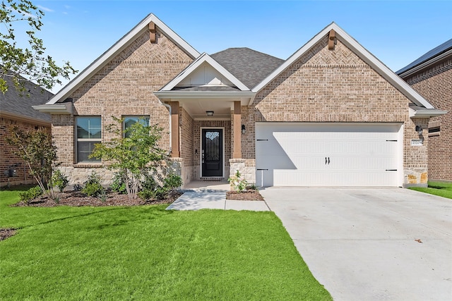 craftsman house with a lawn and a garage