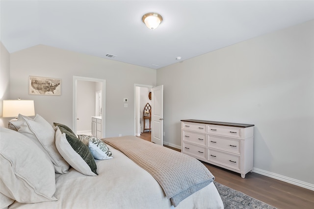 bedroom featuring dark hardwood / wood-style flooring and ensuite bathroom