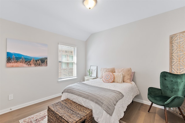 bedroom featuring hardwood / wood-style flooring and vaulted ceiling