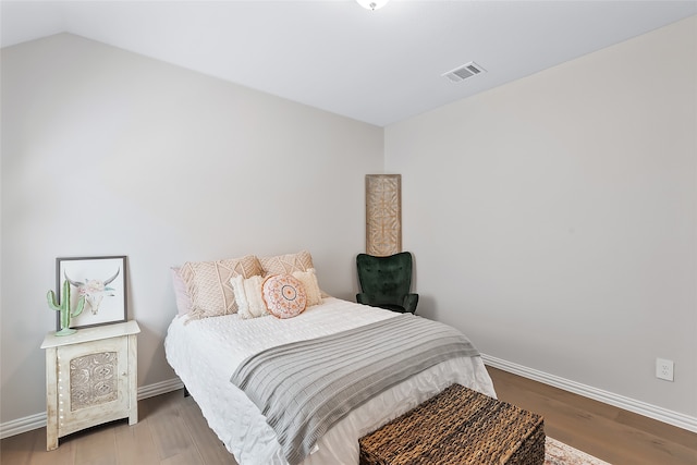 bedroom with hardwood / wood-style flooring