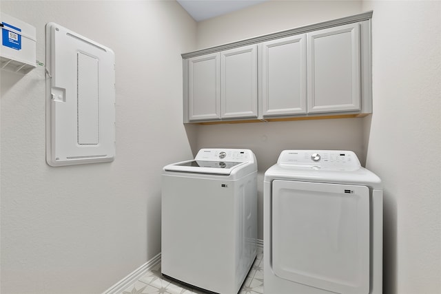 laundry area with cabinets and washing machine and clothes dryer