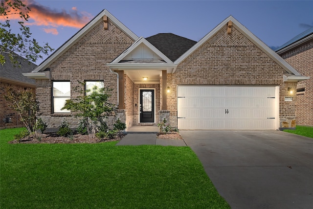 craftsman house with a front yard and a garage