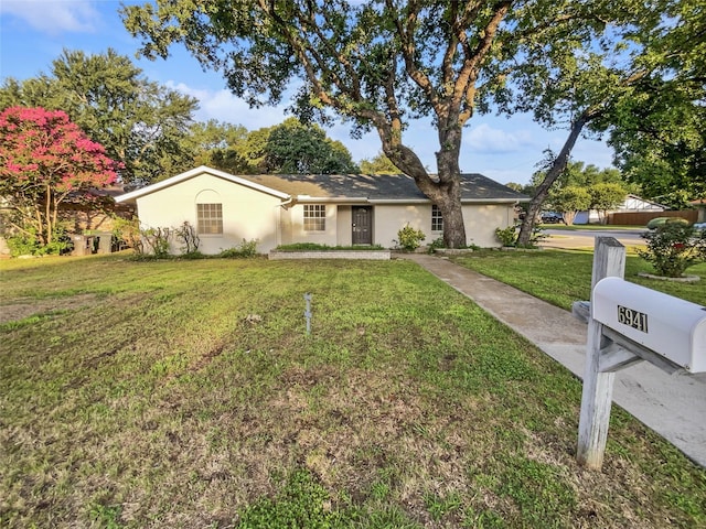 ranch-style home with a front yard