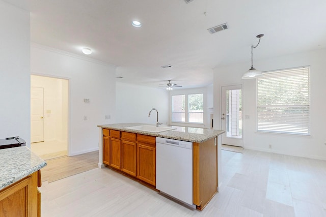 kitchen featuring light stone countertops, sink, white dishwasher, and pendant lighting