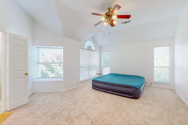 carpeted bedroom featuring ceiling fan and vaulted ceiling