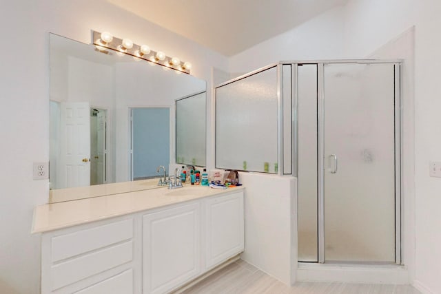 bathroom featuring vanity and a shower with shower door