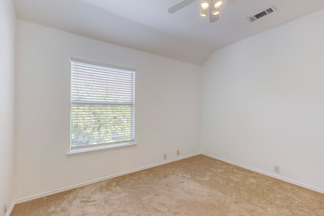 spare room featuring ceiling fan and light carpet