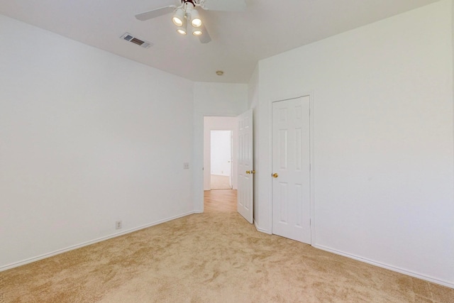 carpeted spare room with ceiling fan