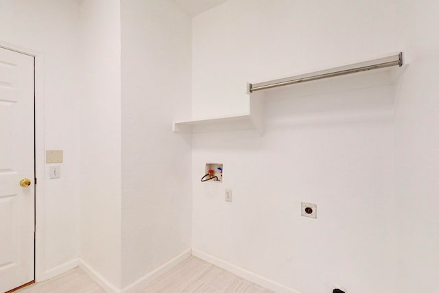 laundry area with electric dryer hookup, light tile patterned floors, and washer hookup